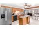 Well-lit kitchen with stainless steel refrigerator and wood cabinets at 11422 W Hidalgo Ave, Tolleson, AZ 85353