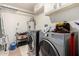 Spacious laundry room with modern appliances and ample storage and tile floor at 11422 W Hidalgo Ave, Tolleson, AZ 85353