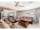 Inviting living room featuring a ceiling fan, wood beam, and comfortable seating at 11422 W Hidalgo Ave, Tolleson, AZ 85353