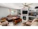 Cozy living room with a ceiling fan, built-in shelving, a TV, and comfortable seating at 11422 W Hidalgo Ave, Tolleson, AZ 85353