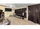 Simple living room with laminate flooring, black curtains, and tv at 11422 W Hidalgo Ave, Tolleson, AZ 85353