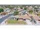 Aerial view showcasing a home with green lawn, landscaped yard, pool, and proximity to neighborhood streets at 1210 W Stottler Dr, Chandler, AZ 85224