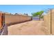 Large backyard is fully fenced with mature block wall and wide gate for access at 1210 W Stottler Dr, Chandler, AZ 85224