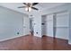 Bedroom with hardwood floors, ceiling fan, and closet area at 1210 W Stottler Dr, Chandler, AZ 85224