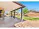 Enjoy outdoor living on this covered patio overlooking a lush, landscaped backyard at 1210 W Stottler Dr, Chandler, AZ 85224