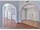Welcoming foyer with arched doorways, double doors, and tile and wood flooring at 1210 W Stottler Dr, Chandler, AZ 85224