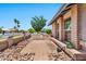 A quaint patio area in the front yard, featuring brick pavers, stone accents, and lush greenery at 1210 W Stottler Dr, Chandler, AZ 85224