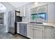 Well-lit kitchen with stainless steel appliances, double sink, and white cabinetry at 1210 W Stottler Dr, Chandler, AZ 85224