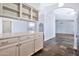 Open kitchen view showcasing white cabinets, countertop, and access to other rooms at 1210 W Stottler Dr, Chandler, AZ 85224