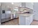 Bright kitchen with stainless appliances, white cabinetry, and eat-in bar area at 1210 W Stottler Dr, Chandler, AZ 85224