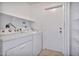 Functional laundry room features a stacked washer and dryer with white shelves at 1210 W Stottler Dr, Chandler, AZ 85224