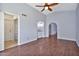 Spacious living room featuring wood floors, a ceiling fan, and neutral paint at 1210 W Stottler Dr, Chandler, AZ 85224