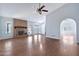 Bright living room with brick fireplace, wood floors, ceiling fan, and neutral paint scheme at 1210 W Stottler Dr, Chandler, AZ 85224