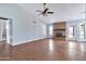 Spacious living room featuring a brick fireplace, wood floors, vaulted ceiling, and ample natural light at 1210 W Stottler Dr, Chandler, AZ 85224