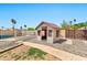 Backyard playhouse near the pool is fenced with mature trees providing shade at 1210 W Stottler Dr, Chandler, AZ 85224
