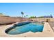 Sparkling pool with stacked stone and blue tile accents, set in a private backyard oasis with pavers at 1210 W Stottler Dr, Chandler, AZ 85224