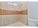 Tiled shower with decorative inlay and small window for natural light at 1210 W Stottler Dr, Chandler, AZ 85224