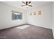 Bright bedroom with neutral carpet, ceiling fan and large windows providing ample natural light at 1225 N 36Th St # 2119, Phoenix, AZ 85008