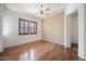 Bright bedroom with hardwood floors, plantation shutters, and a ceiling fan at 1225 N 36Th St # 2119, Phoenix, AZ 85008