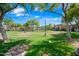 Expansive community park with lush green grass and mature trees at 1225 N 36Th St # 2119, Phoenix, AZ 85008