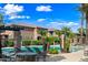 Resort-style community pool surrounded by lounge chairs, tables, and lush palm trees at 1225 N 36Th St # 2119, Phoenix, AZ 85008