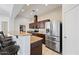 Well-lit kitchen with stainless steel refrigerator, bar stool seating, and modern cabinetry at 1225 N 36Th St # 2119, Phoenix, AZ 85008