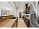 Kitchen with stainless fridge, view to laundry room, and open layout to living area at 1225 N 36Th St # 2119, Phoenix, AZ 85008