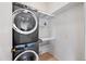 Convenient laundry room features stacked washer and dryer, storage shelves, and folding area at 1225 N 36Th St # 2119, Phoenix, AZ 85008