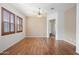 Bright living room with wood-look flooring, plantation shutters and ceiling fan at 1225 N 36Th St # 2119, Phoenix, AZ 85008