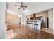 Spacious living room featuring hardwood floors, a ceiling fan, and an open layout to the kitchen at 1225 N 36Th St # 2119, Phoenix, AZ 85008