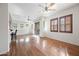 Spacious living room with hardwood floors, a ceiling fan, and a sliding door leading to a balcony at 1225 N 36Th St # 2119, Phoenix, AZ 85008