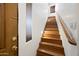Inviting stairway with wooden steps and railing leads to the upper level at 1225 N 36Th St # 2119, Phoenix, AZ 85008