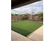 Backyard with turf, patio area, and a view of the neighboring houses at 12518 W Milton Dr, Peoria, AZ 85383