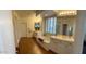 Spacious bathroom with double vanities, a soaking tub, and plenty of natural light at 12518 W Milton Dr, Peoria, AZ 85383