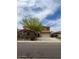 Charming two-story home with a three-car garage and desert landscaping with a tree-lined street at 12518 W Milton Dr, Peoria, AZ 85383
