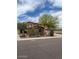 Charming two-story home with a three-car garage, desert landscaping and a tree-lined street at 12518 W Milton Dr, Peoria, AZ 85383