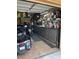 Well-organized garage with cabinets and ample lighting for projects and storage, as well as two motorcycles at 12518 W Milton Dr, Peoria, AZ 85383