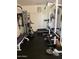 Spacious home gym with workout equipment and machines, and a door to the outside at 12518 W Milton Dr, Peoria, AZ 85383