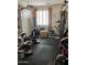 Home gym with weights, workout equipment, a door, and a large window for natural light at 12518 W Milton Dr, Peoria, AZ 85383