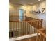 Upstairs hallway with wood railing looking down into the stairwell, and decor on the walls at 12518 W Milton Dr, Peoria, AZ 85383