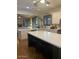Bright kitchen featuring white cabinets, stainless steel appliances, a center island, and breakfast bar seating at 12518 W Milton Dr, Peoria, AZ 85383