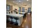 Bright kitchen featuring white cabinets, stainless steel appliances, a center island, and a dining table at 12518 W Milton Dr, Peoria, AZ 85383