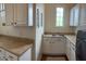 Bright laundry room boasts a convenient sink and ample cabinet storage for an organized space at 12518 W Milton Dr, Peoria, AZ 85383