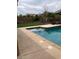 Backyard pool and patio area with landscaping and seating at 12518 W Milton Dr, Peoria, AZ 85383