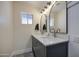 Elegant bathroom featuring double vanity sinks, stylish mirrors, and tiled walls at 1263 W Devonshire St, Mesa, AZ 85201