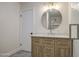 Bathroom featuring a vanity with modern fixtures, round mirror, vanity lighting, hardware and adjacent door at 1263 W Devonshire St, Mesa, AZ 85201