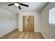 Bedroom featuring light wood flooring, bi-fold closet doors, and neutral walls at 1263 W Devonshire St, Mesa, AZ 85201