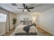 This bedroom has a soft, inviting bed with a patterned rug, and the ceiling fan is the focal point at 1263 W Devonshire St, Mesa, AZ 85201