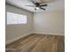 Bright bedroom with light wood flooring, a window, and neutral walls at 1263 W Devonshire St, Mesa, AZ 85201