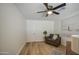 Inviting bedroom featuring light wood floors and a comfortable armchair, perfect for relaxing at 1263 W Devonshire St, Mesa, AZ 85201